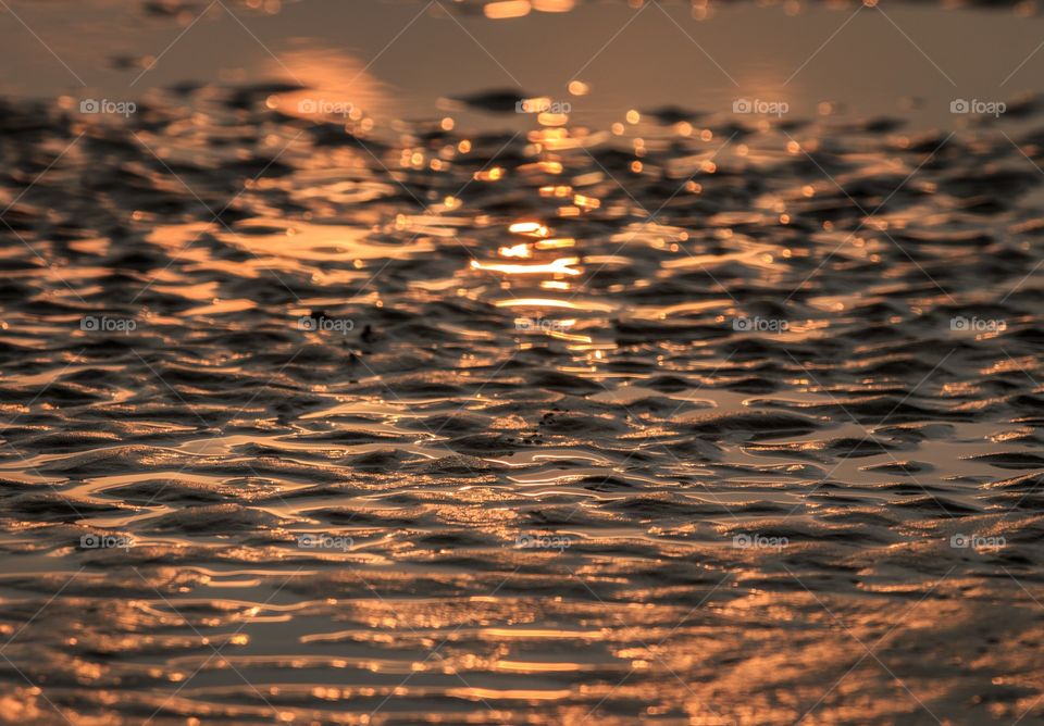 natural light of setting sun shining and blending inside sea water