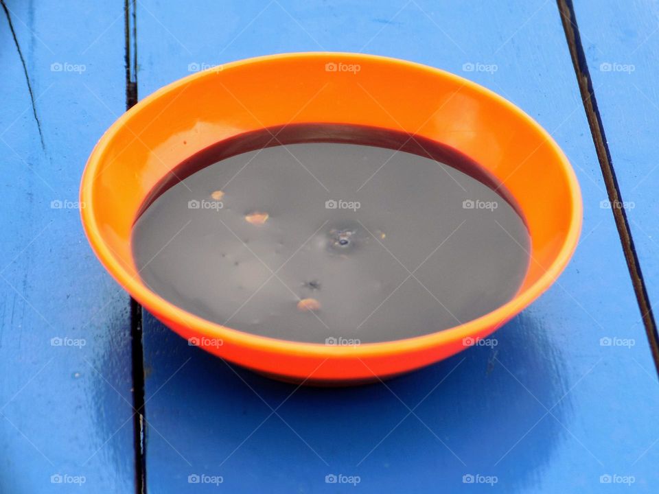 Soy sauce sauce in a plastic bowl on the table