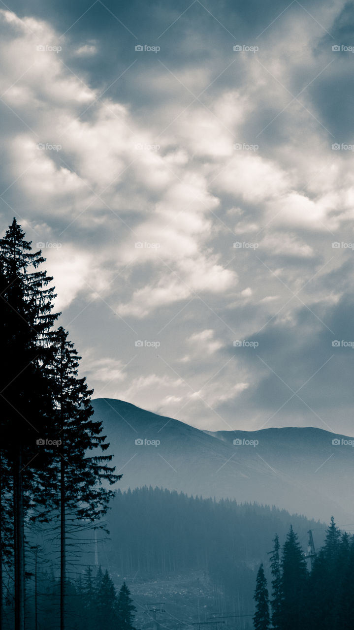 An inspiring mountain landscape. Tatry mountains in Slovakia. A beautiful wallpaper for smartphone screen. Monochrome blue abstract gradient with perspective.