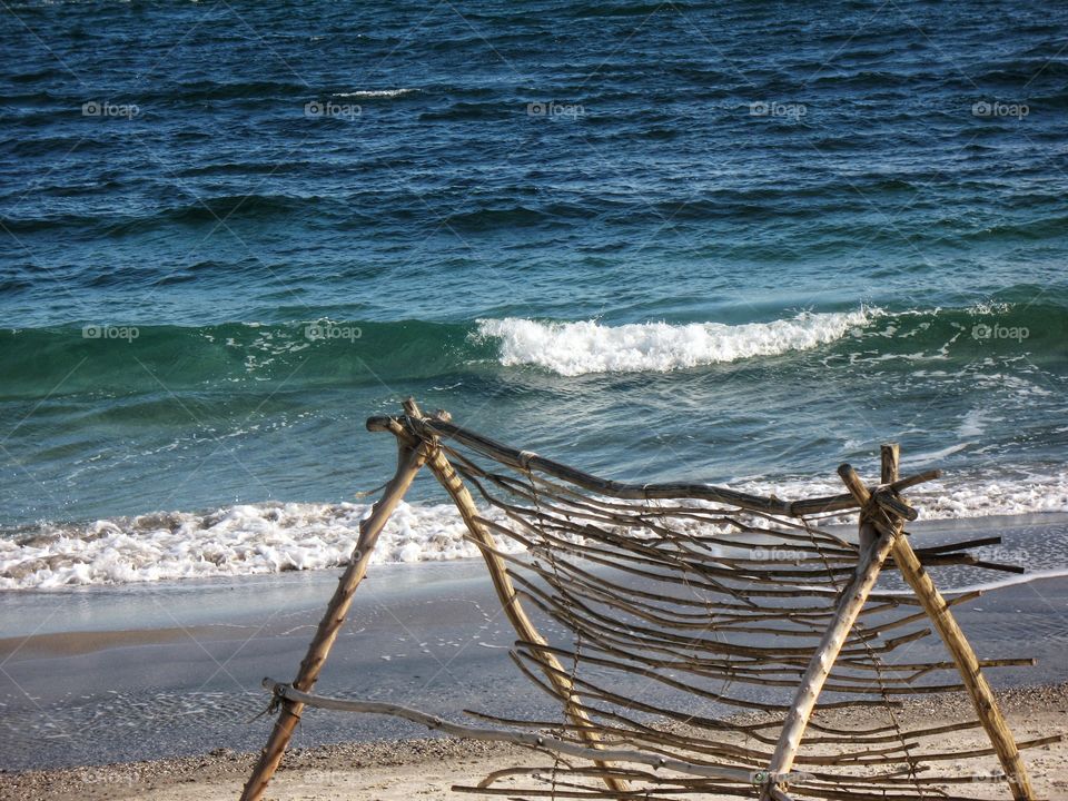 construction of branches on the beach конструкция из веток на пляже