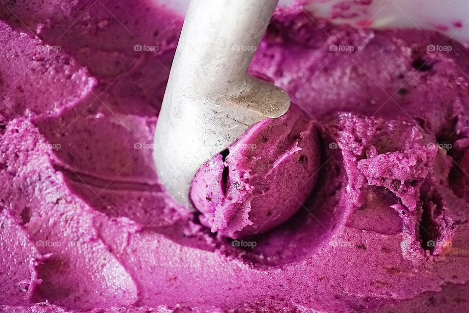 Blueberry Sherbet ice cream in the ice cream tank. Soft focus.