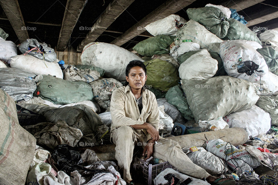 A copper collector take a break under the overpass at Ancol, North Jakarta, Indonesia. Scraps copper will be sold to factories in the Industrial area in Jakarta.