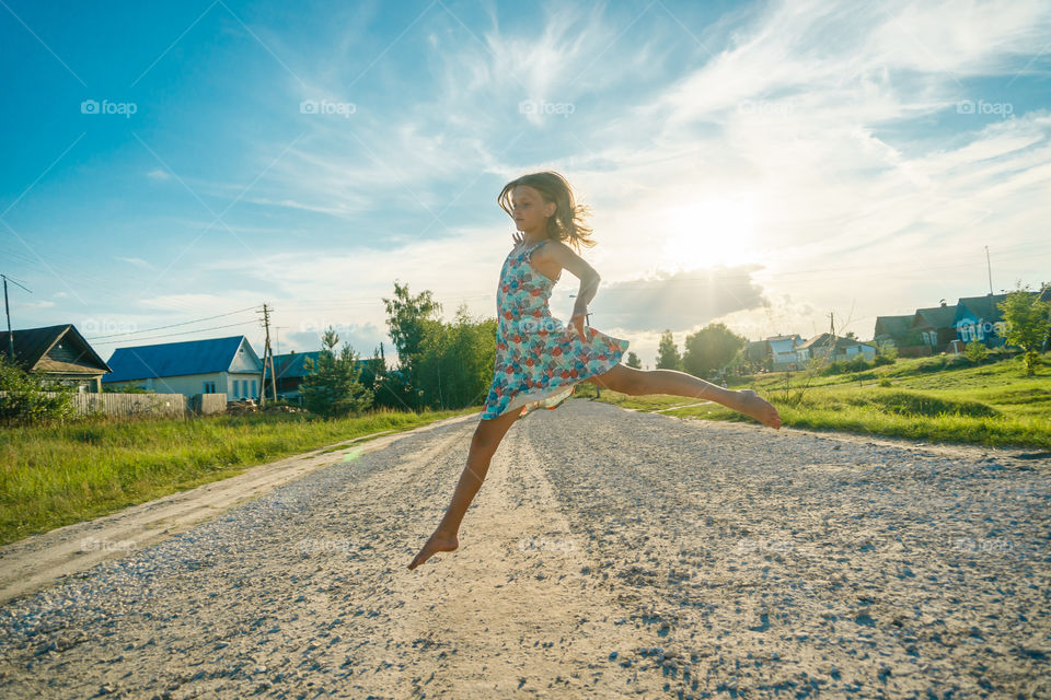 Girl is jumping on the countryside