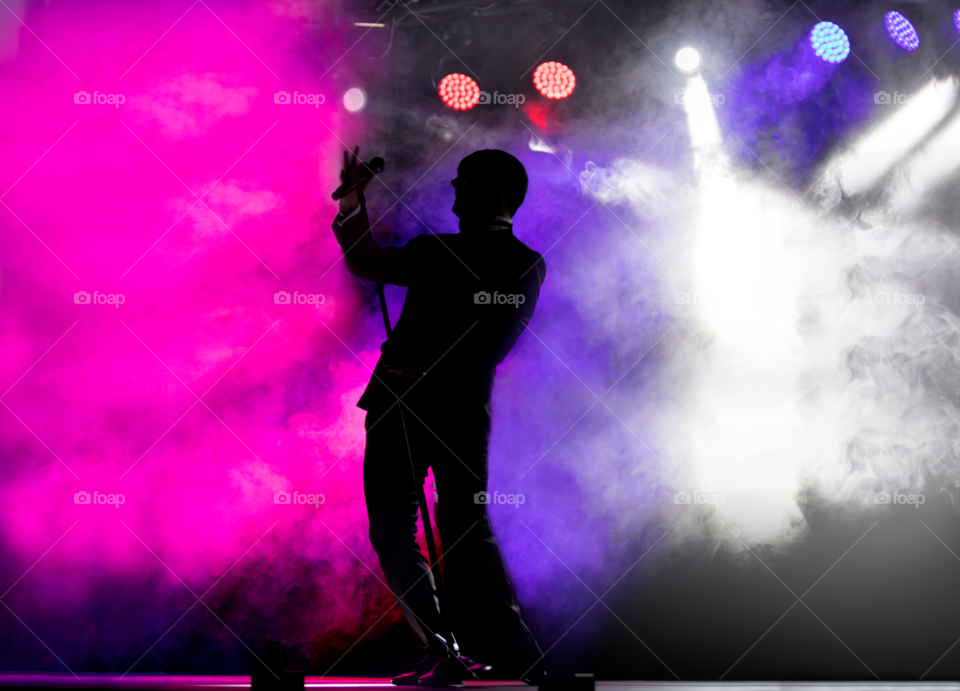 Silhouette of singer with colorful background