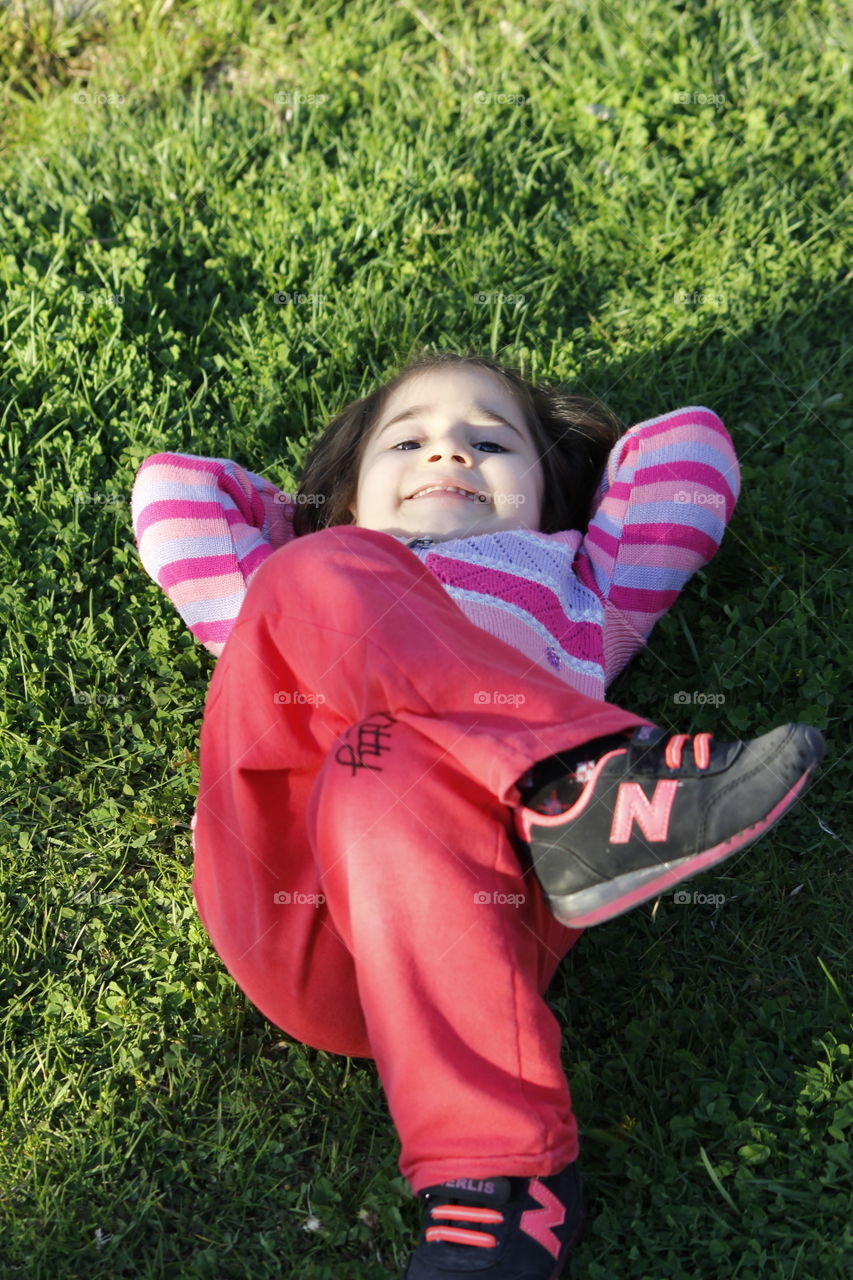 Small kid sleeping on grass