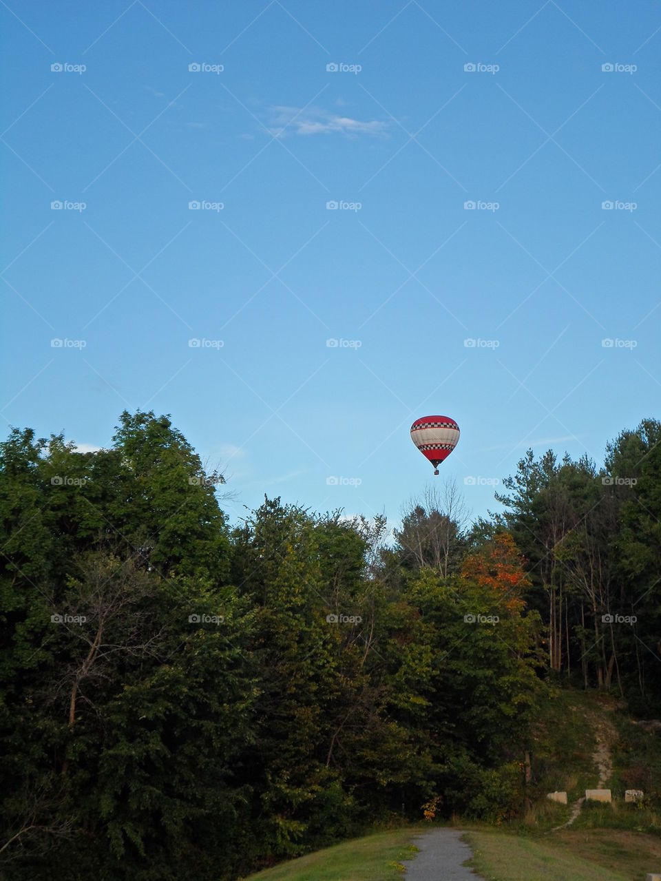 Hot air balloon over walk path