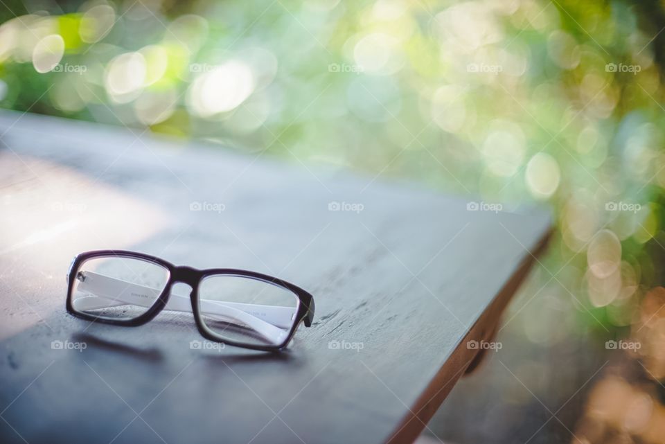 Glasses one wooden table in the park 
