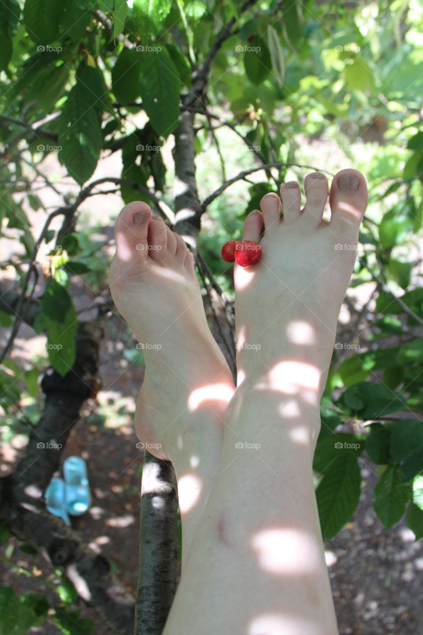 Beautiful feet with cherries on toes.