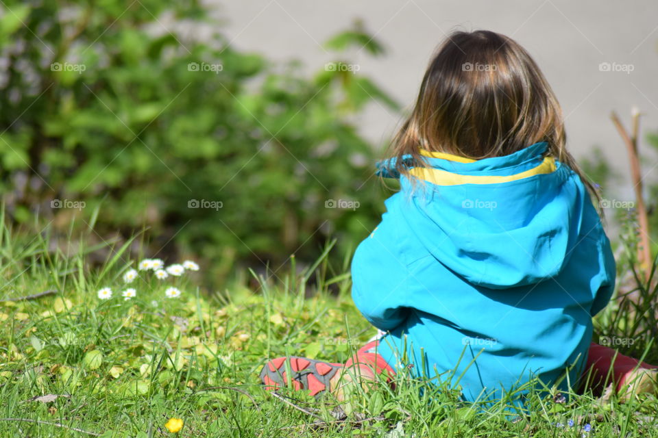 Child sitting on meadow 