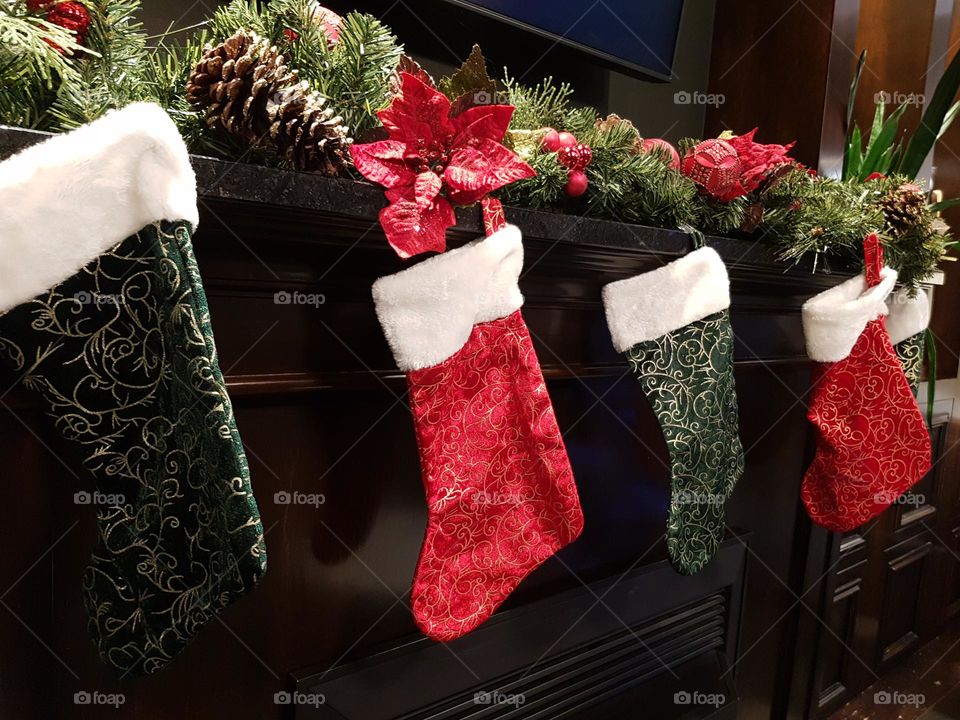 Stockings hanging from a fireplace waiting for Santa's presents