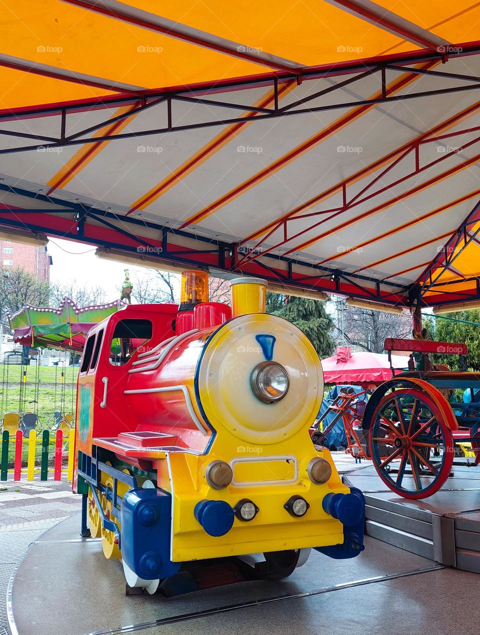 Colorful locomotive in the children's amusement park.  Dominance geometric shapes: circle,  triangle, and rectangle