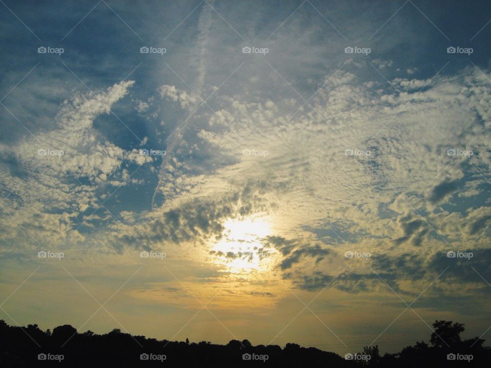 A beautiful sunrise full of white fluffy clouds
