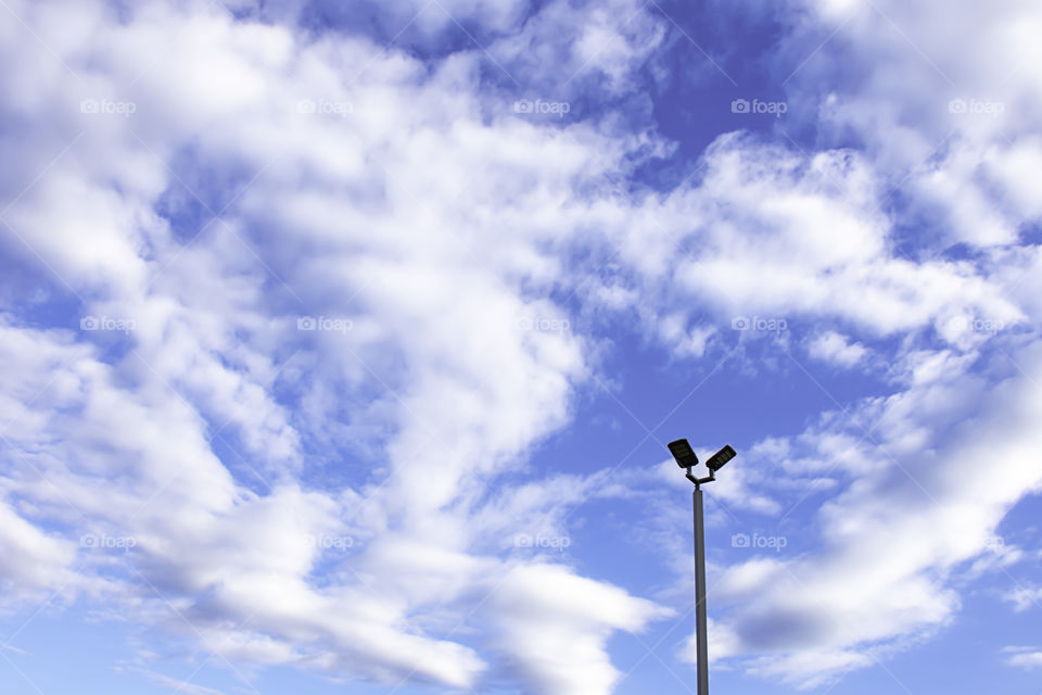 Street lamps with bright blue sky.