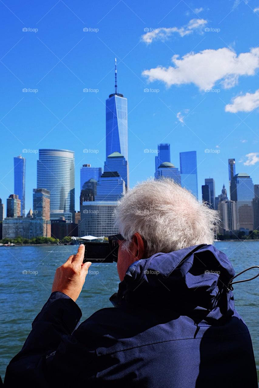 Man photographer, man photographing New York City, Person taking pictures, boat ride around the city, people of the world, tourist in New York City, snapshots of the skyline 