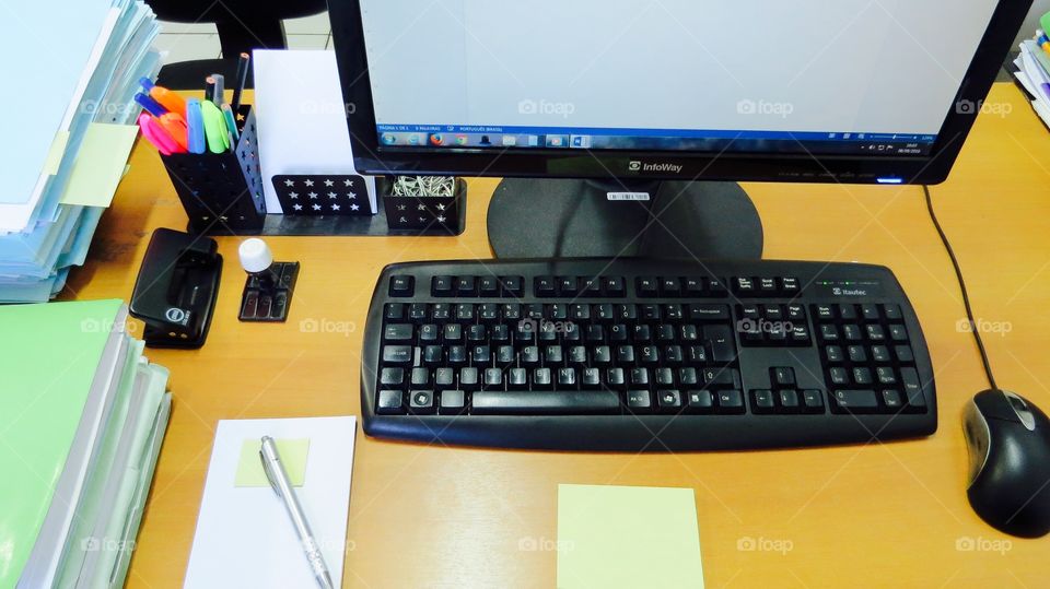 desk with old computer model CPU , mouse and internet cables , calendar , notepad , pens and annotations