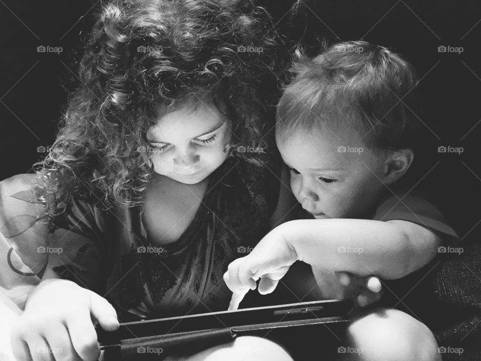 Close-up of brother and sister using tablet