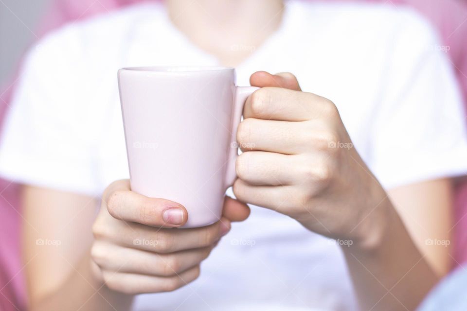 Person holding a cup.
