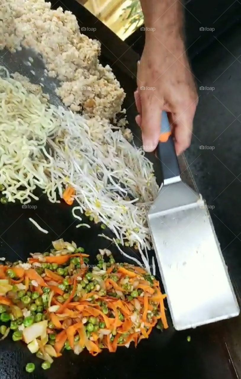 Making fried rice,  noodles, beansprouts, and mixed vegetables on the griddle.....Japanese hibachi night.