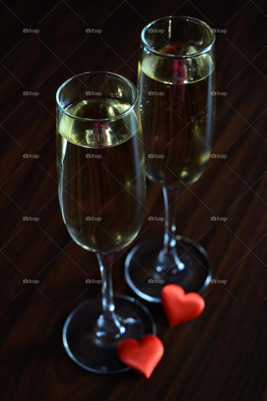 two champagne glasses dark background