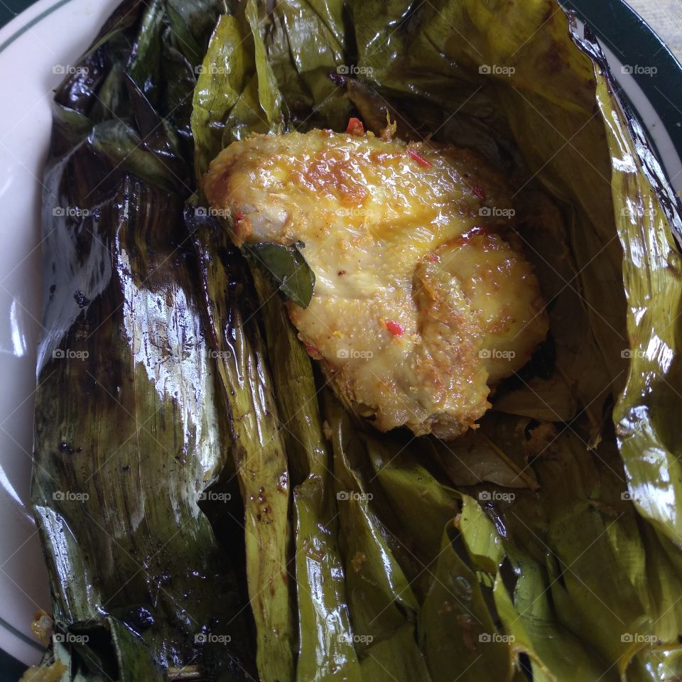 Steamed chicken wrapped in banana leaves