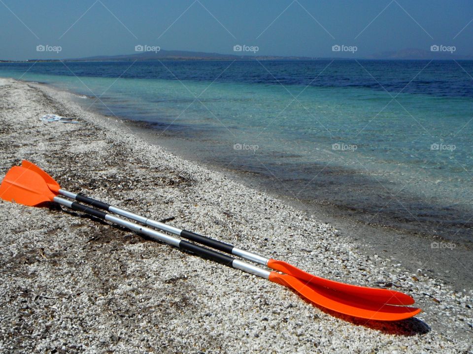 orange color story: orange paddle in front of sea