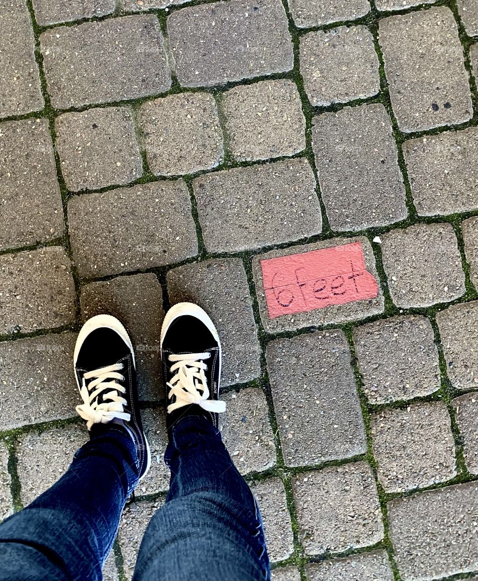 Standing 6 feet apart while waiting in line to go into a store USA America 