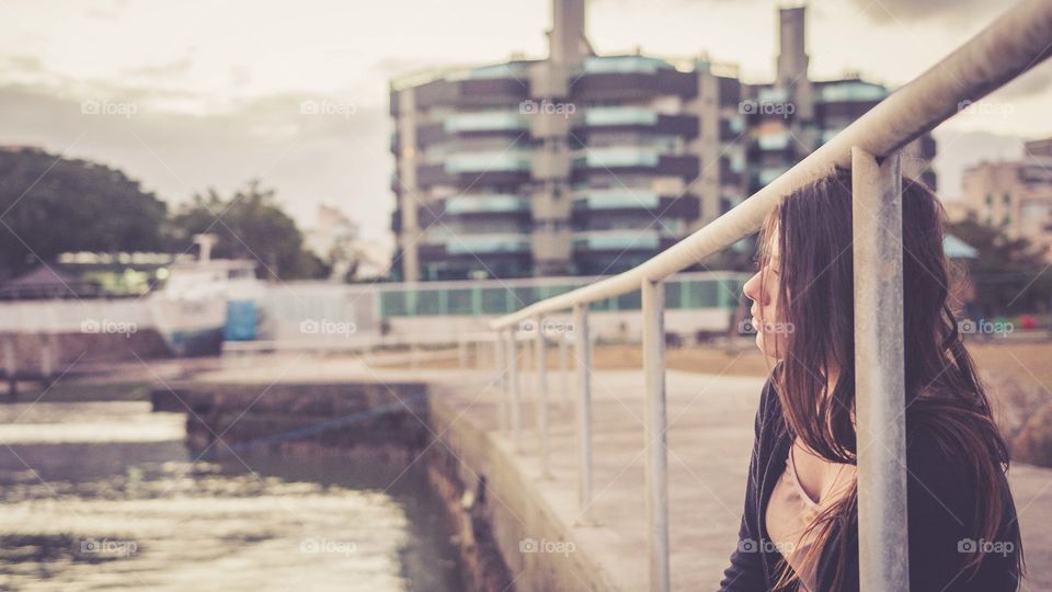 Sad woman sitting near the pool