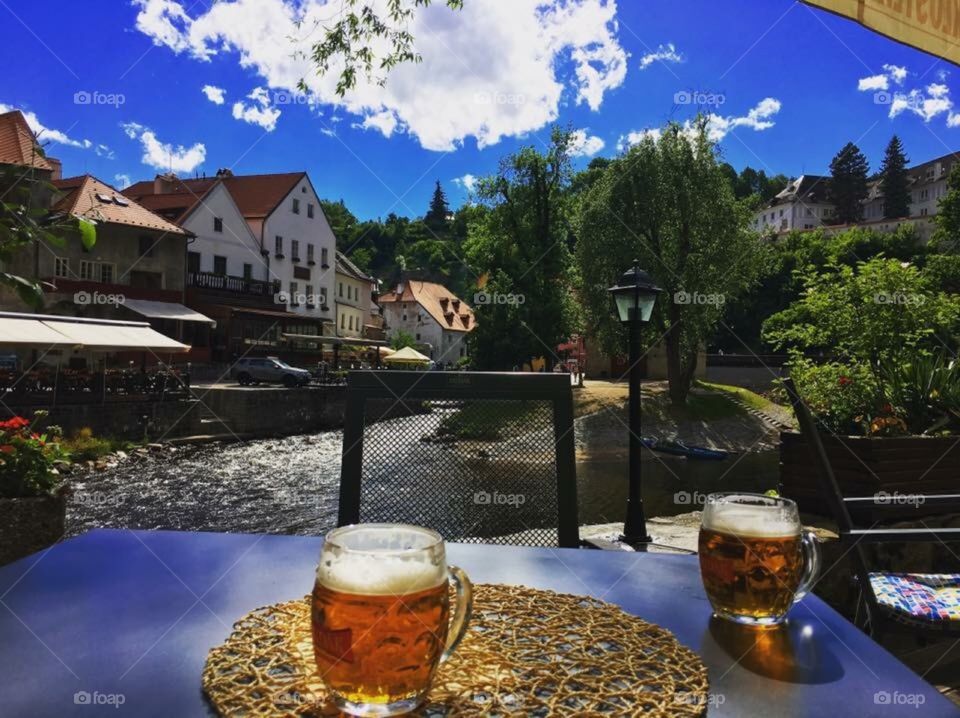 Drinking two beers by the lake in Cesky Krumlov, Czech Republic In the sunshine 