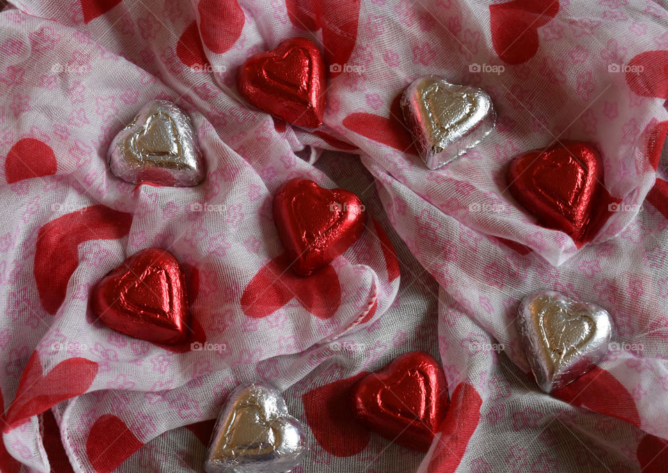 Heart shaped chocolate candy on fabric background