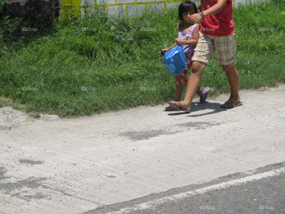 mother and child on sidewalk