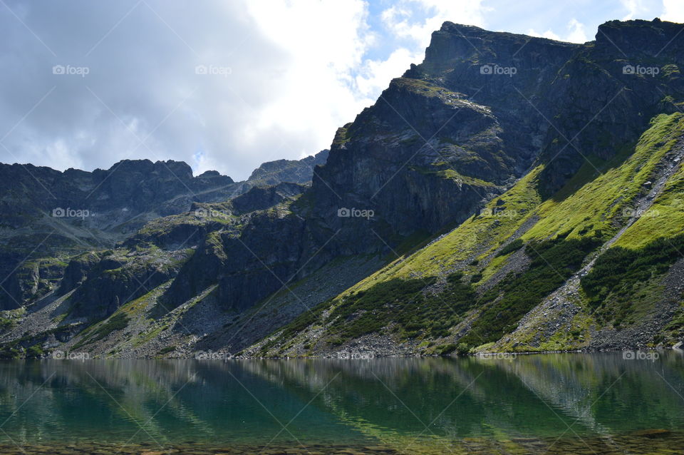 Rocky mountain reflecting on lake