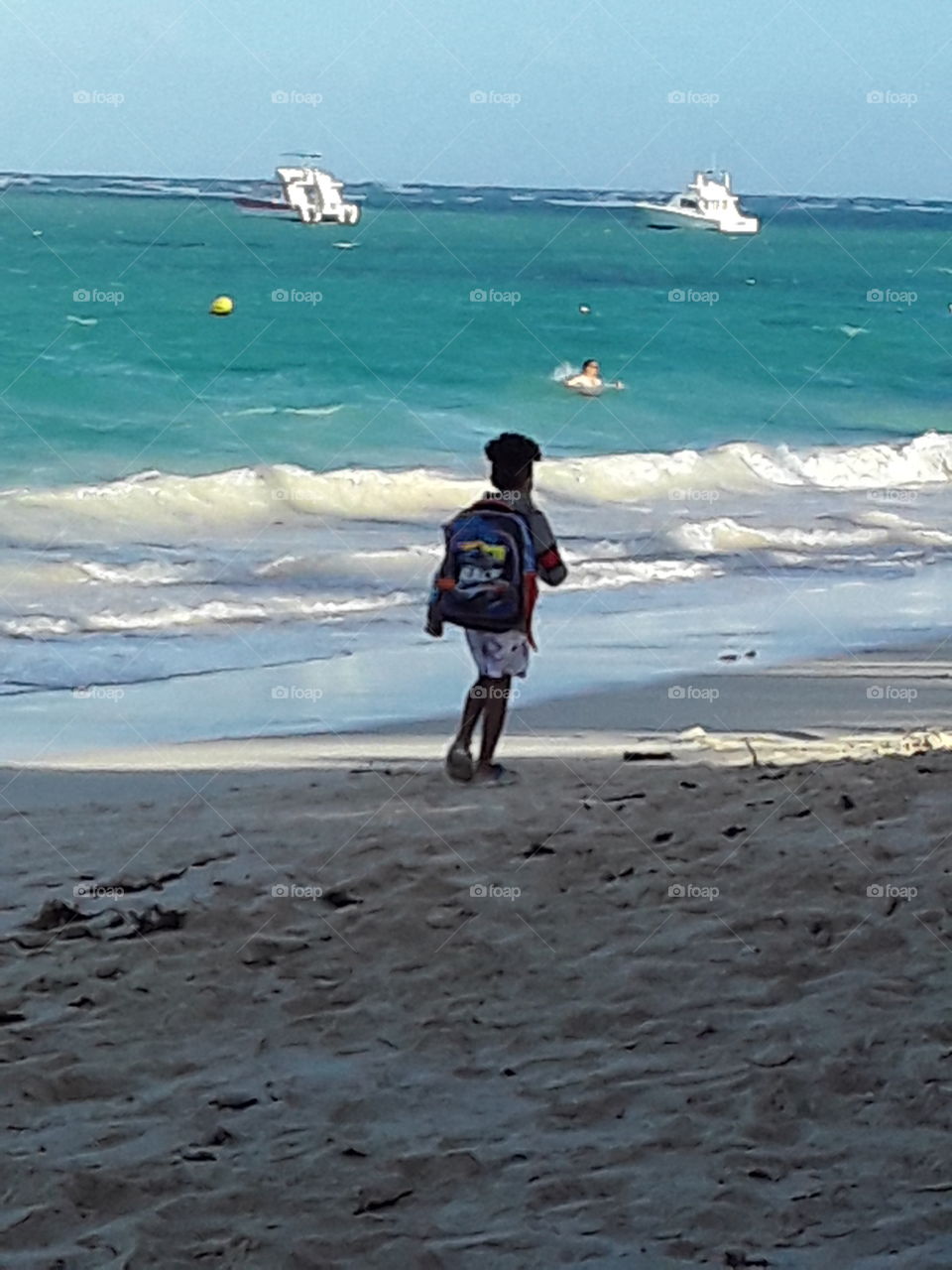 child walks along the beach