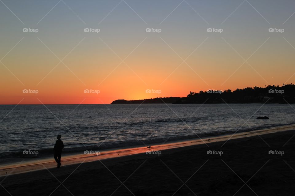 Silhouette of person at beach during sunset