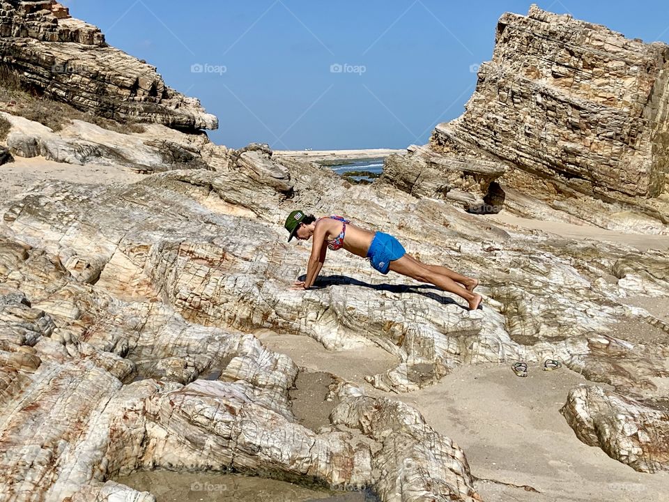 Plank on rocks. Exercise outdoor 