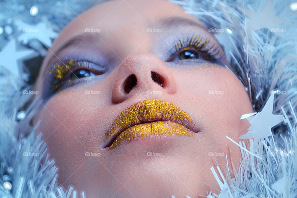 Headshot of a woman with glittering makeup