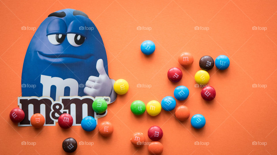M&M's mascot on orange background