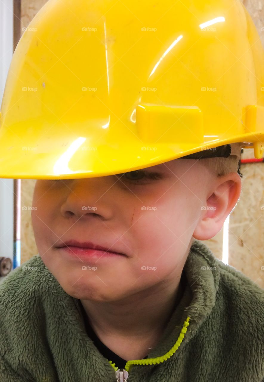 Boy playing. Having fun in the little to big helmet