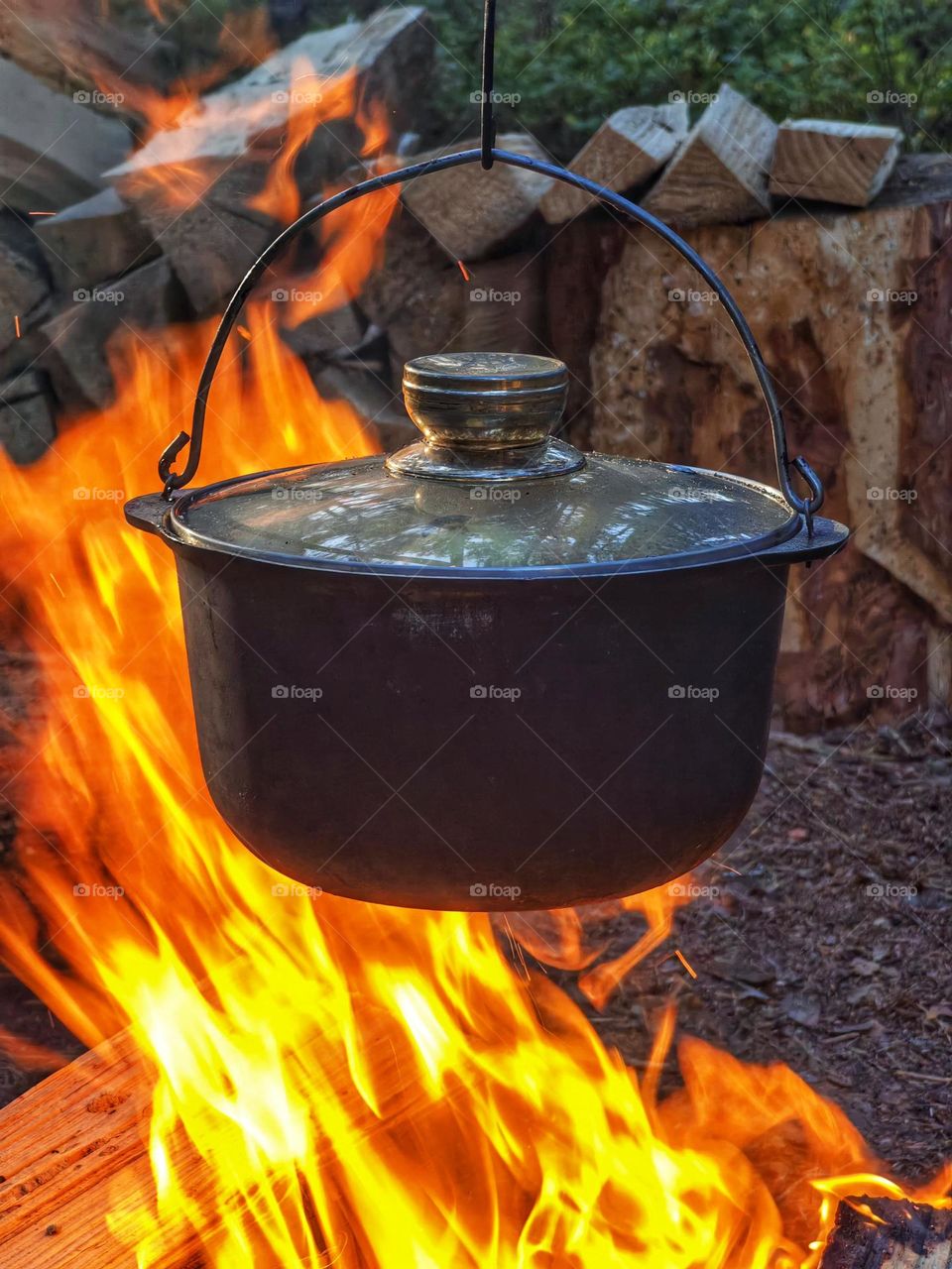 on the fire hangs a pot with the food of a tourist