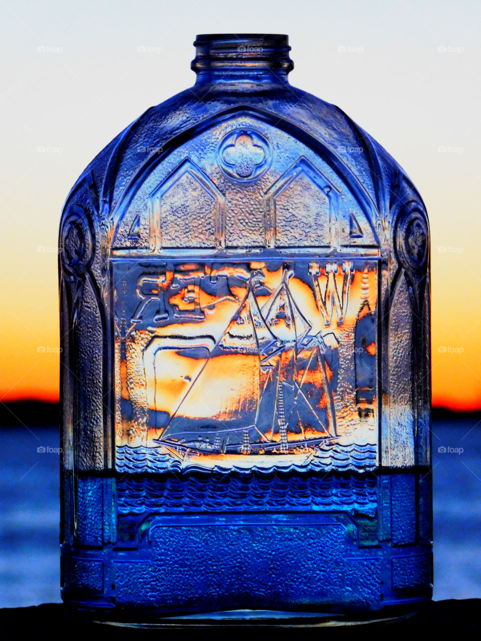 Blue sailboat silhouette! Sunsetting in the magical bottle! 
Captured this magnificent sunset in the bottle over the Choctawhatchee Bay! Beauty in nature!