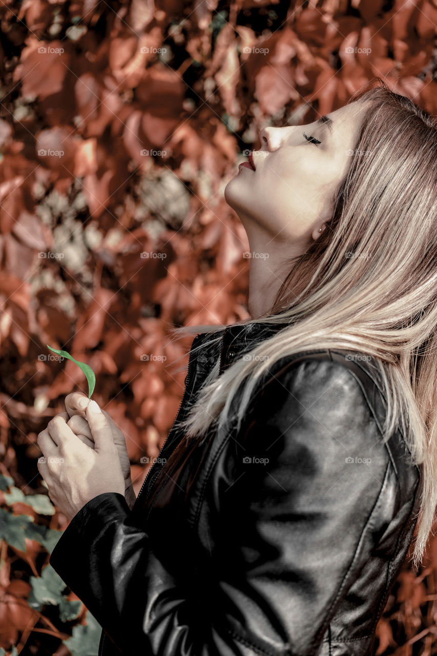 Woman halding a green leaf