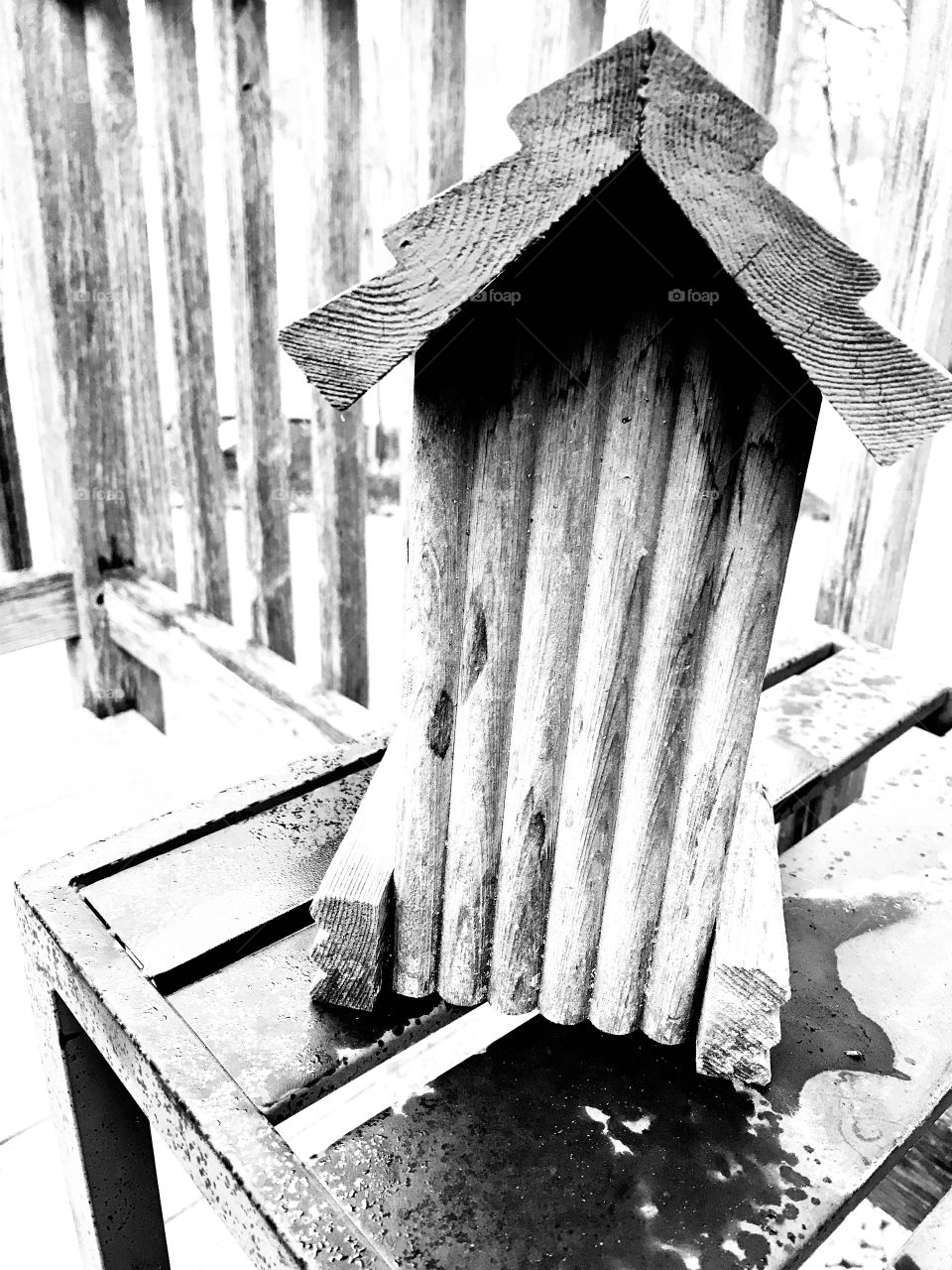 Wooden birdhouse sitting on table makes for a fun setting to snap a couple of photos. 