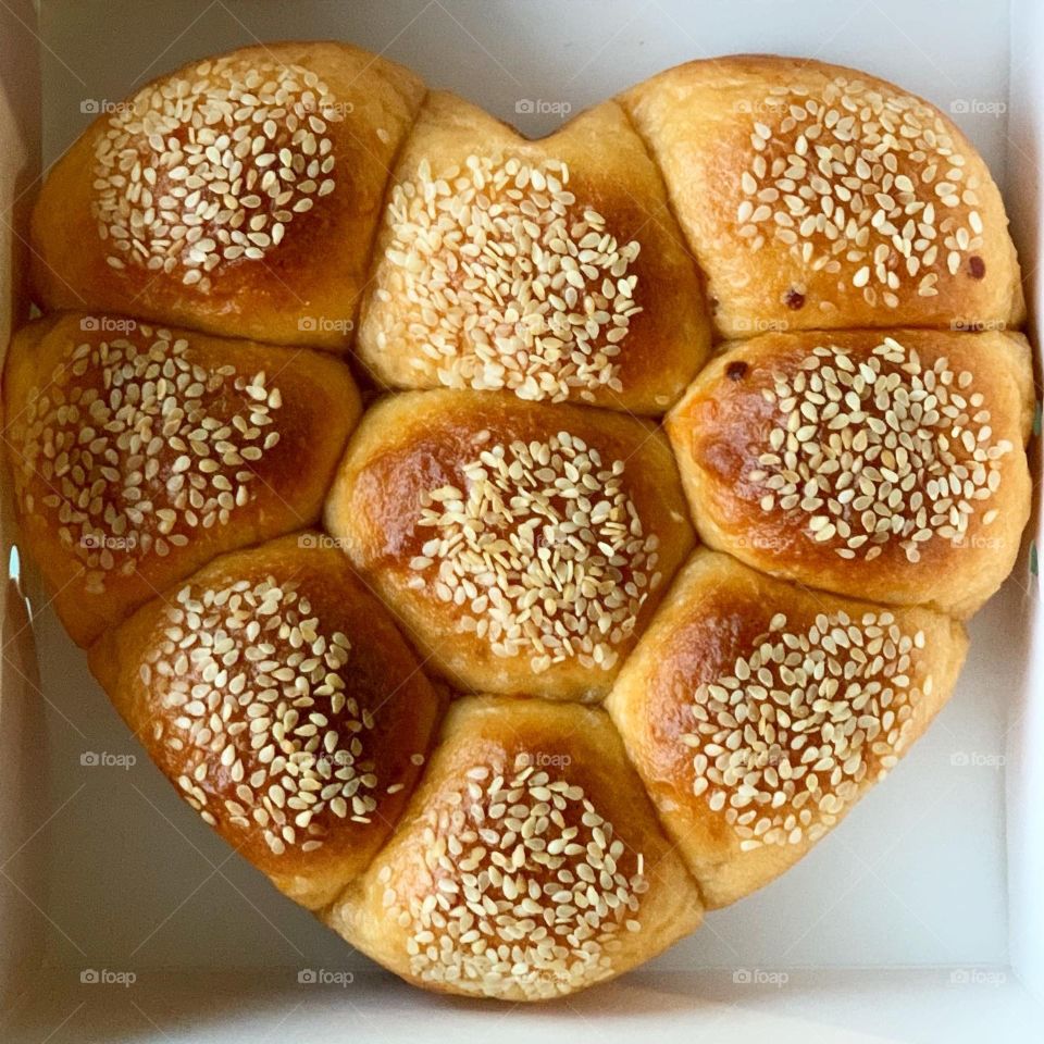 Wholesome healthy treats consisting of foccacia , heart shaped tomato cheese buns, almond butter for afternoon tea snack 