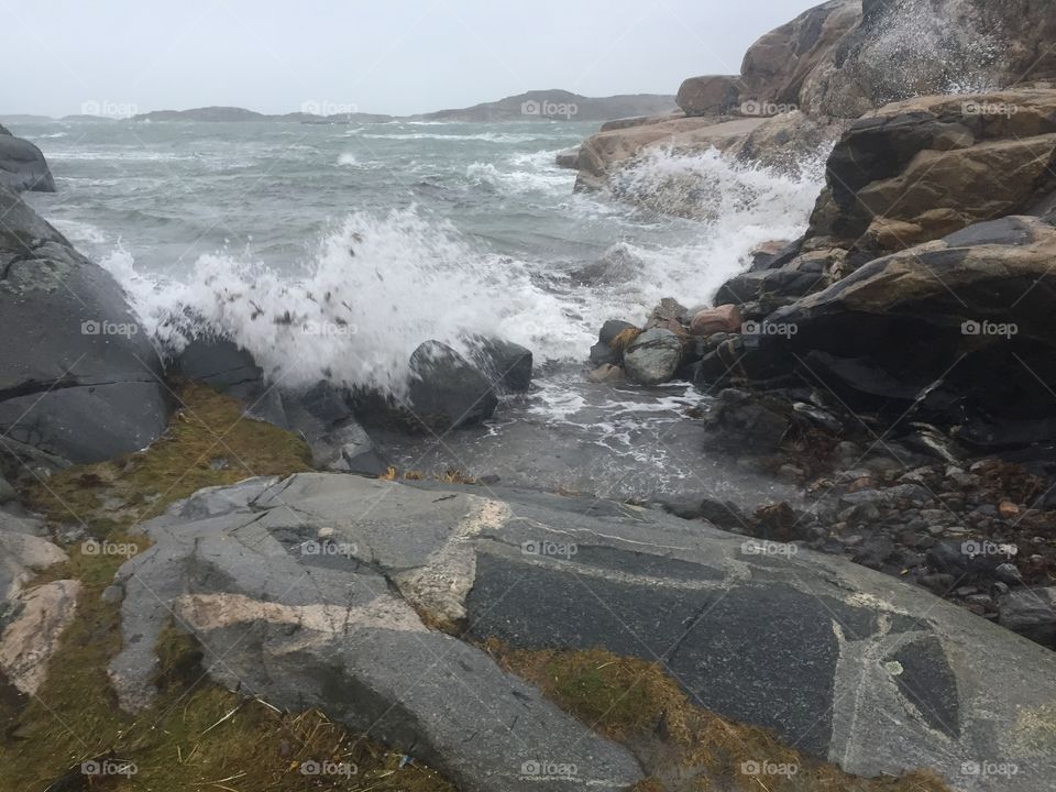 View of wave hitting rocks