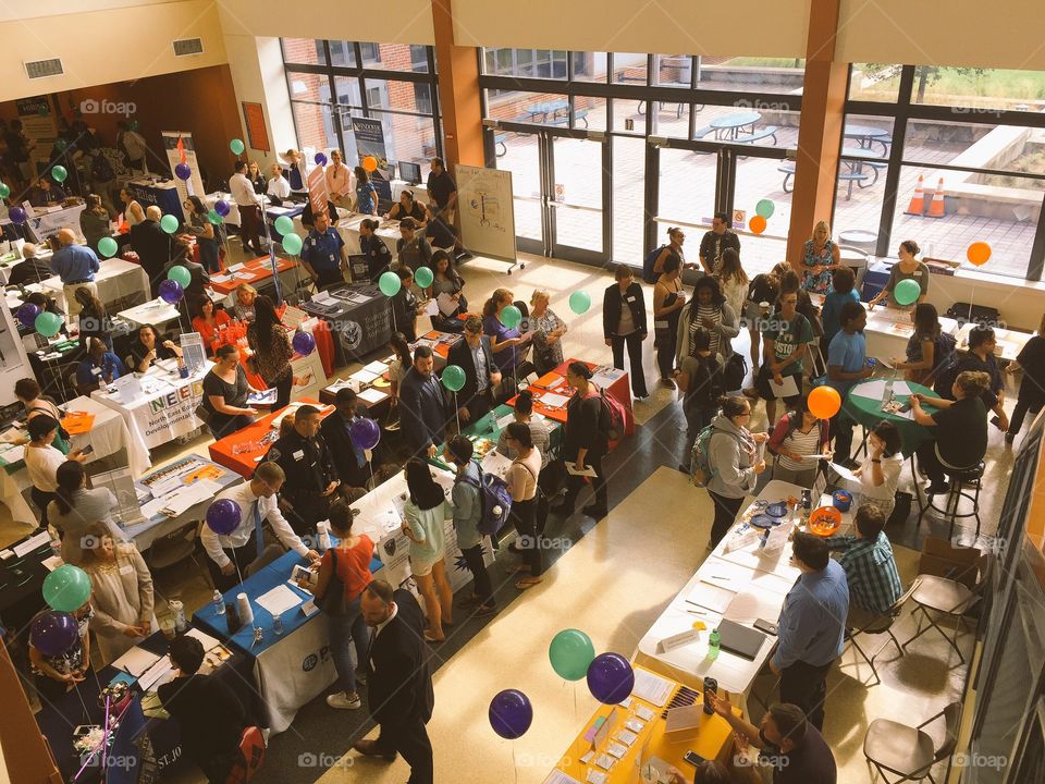 Overhead view of an indoor career fair event at a college 