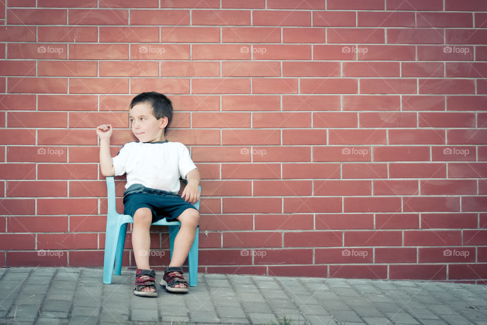 Boy sitting on a chair