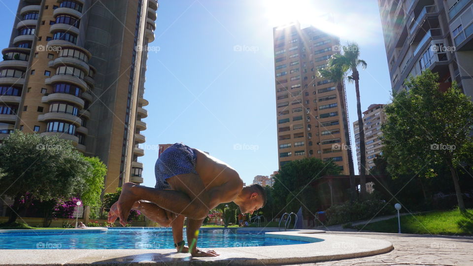 Yoga#training#exercise#balance#position#concentrated#swimmingpool#urban#buildings