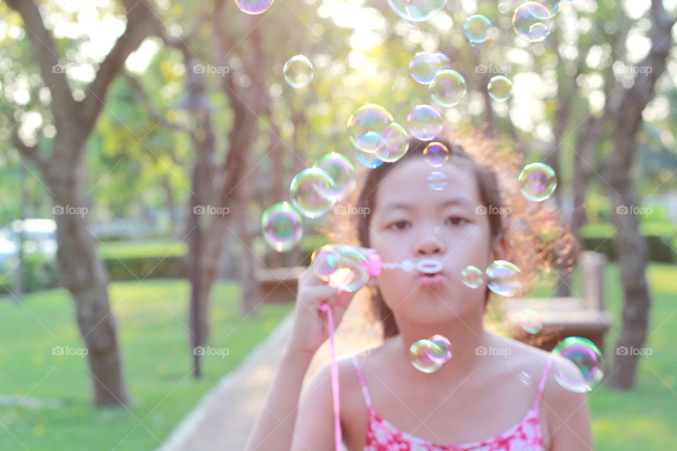 Girl playing bubble 
