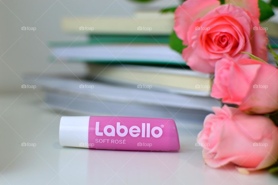 Labello cocoa butter lip next to the books