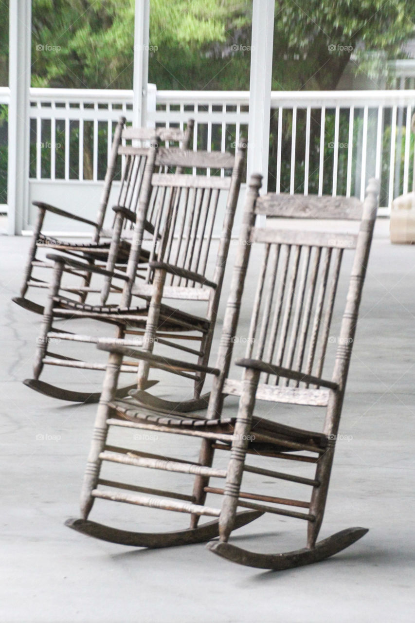 3 rocking chairs in a row