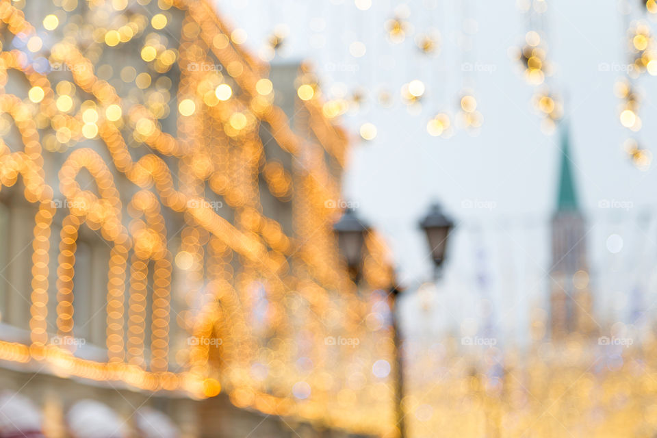 Bokeh of Christmas lights in the tsreet in winter